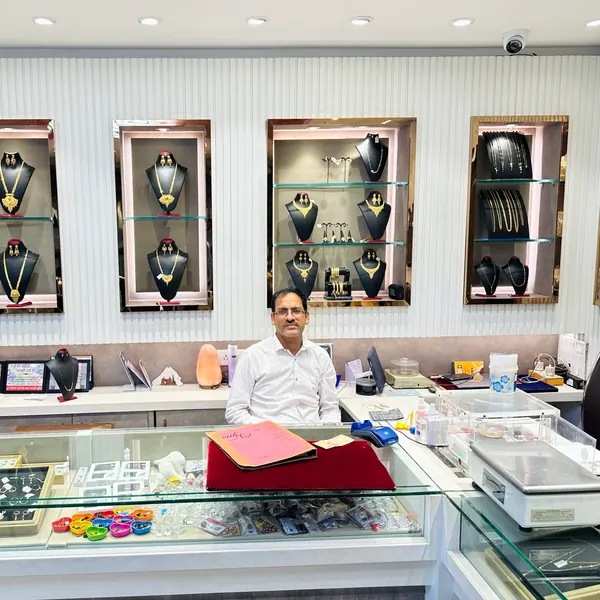 Showroom counter with gold jewellery wall and gemstone trays